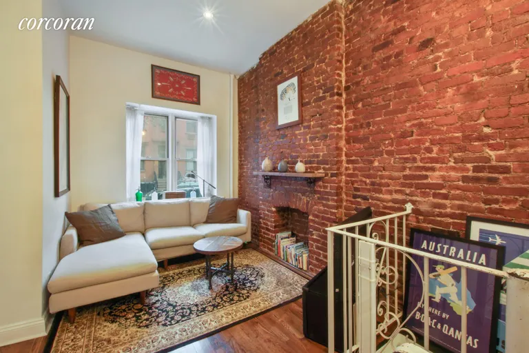 New York City Real Estate | View 338 West 19th Street, 1C | Exposed brick with decorative fireplace | View 2