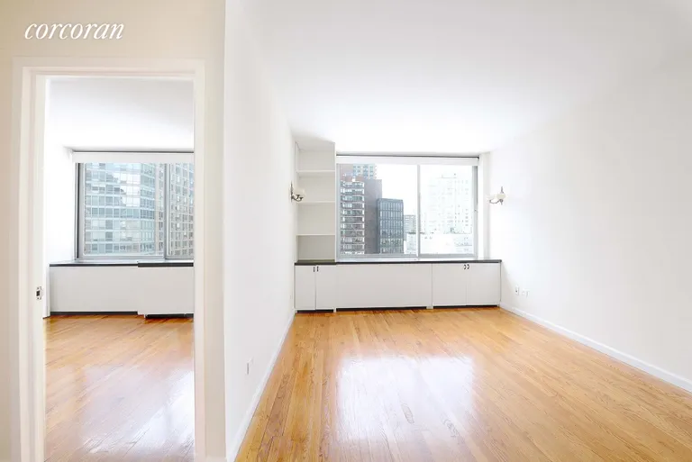 New York City Real Estate | View 111 West 67th Street, 22A | Living room / bedroom split view | View 2
