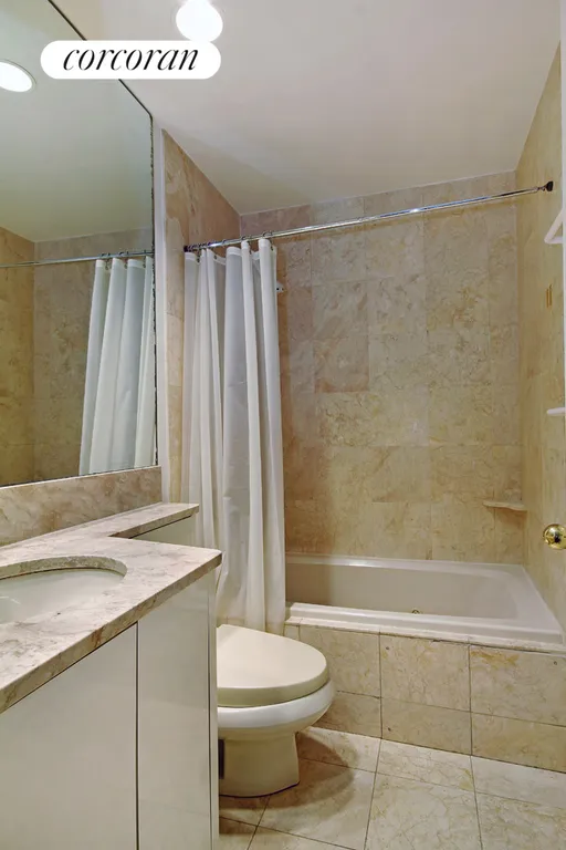 New York City Real Estate | View 100 United Nations Plaza, 6F | Marble Bathroom with Jacuzzi tub | View 5
