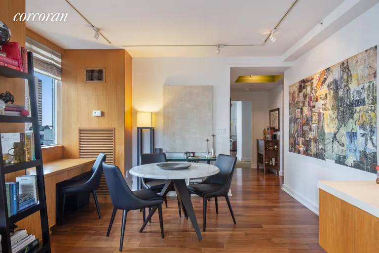 New York City Real Estate | View 60 East 55th Street, 28A | Dining area in living room with built-in desk | View 2