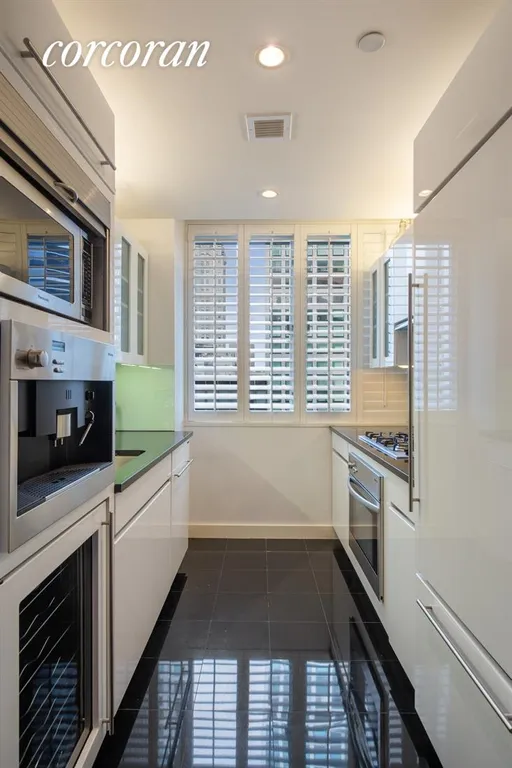 New York City Real Estate | View 60 East 55th Street, 28A | Windowed kitchen with high-end appliances | View 3