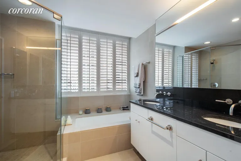 New York City Real Estate | View 60 East 55th Street, 28A | Windowed bathroom with dual sink vanity  | View 5