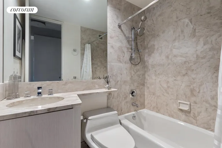 New York City Real Estate | View 100 United Nations Plaza, 40C | 2nd Bedroom's ensuite marble bathroom | View 8