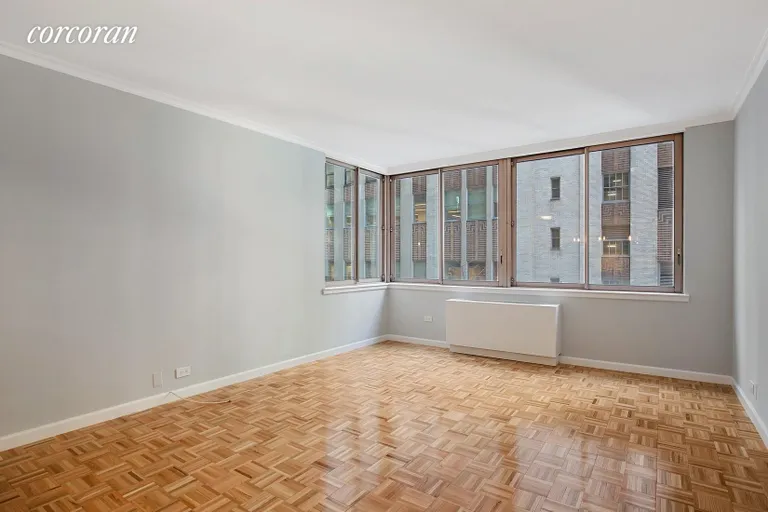 New York City Real Estate | View 235 East 40th Street, 3F | Corner Living Room with 6 Oversized Windows  | View 3