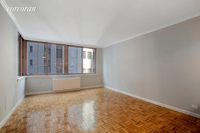 New York City Real Estate | View 235 East 40th Street, 3F | Corner Living Room with 6 Oversized Windows | View 4
