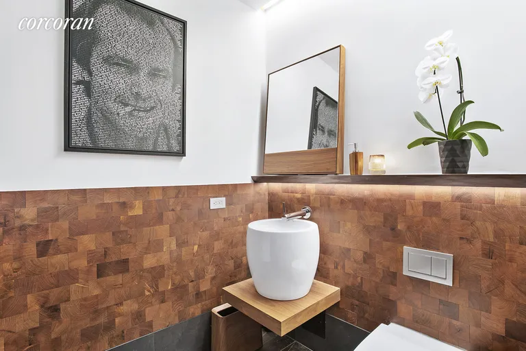 New York City Real Estate | View 155 West 18th Street, 503 | Powder room with hidden washer/dryer | View 7