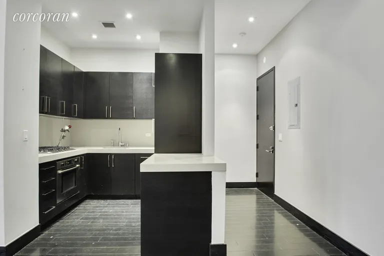 New York City Real Estate | View 254 Park Avenue South, 9A | Tucked away kitchen with hidden washer/dryer | View 2