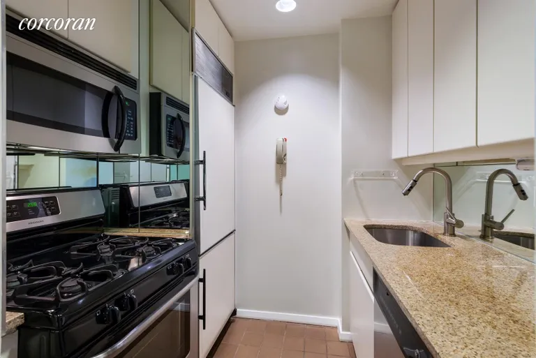 New York City Real Estate | View 100 United Nations Plaza, 8F | Kitchen with black and stainless steel appliances | View 2