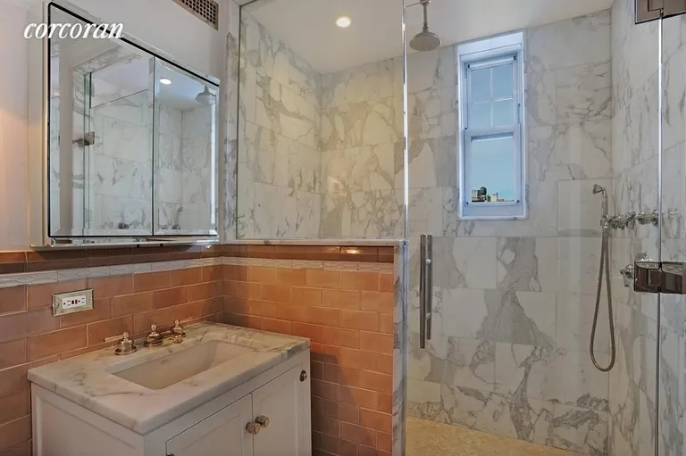 New York City Real Estate | View 27 West 72nd Street, 810 | Marble clad and windowed master bathroom | View 4