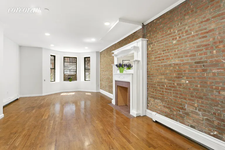 New York City Real Estate | View 107 West 120th Street, 1A | Living room with original fireplace mantel | View 3