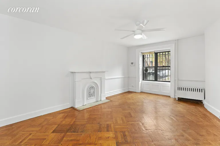 New York City Real Estate | View 294 Saint James Place, 1 | Front bedroom with decorative fireplace  | View 4