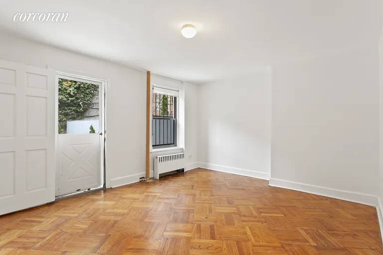 New York City Real Estate | View 294 Saint James Place, 1 | Rear bedroom with garden entrance  | View 5