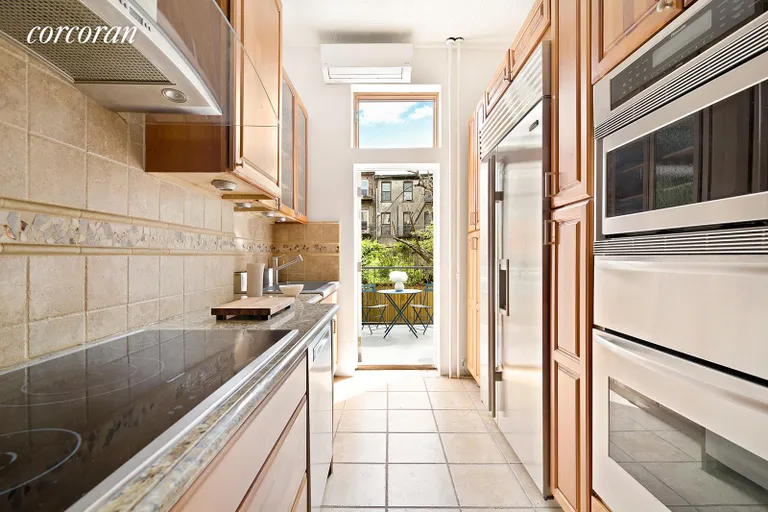 New York City Real Estate | View 390 Bergen Street, 1 | Kitchen with door leading to deck and garden | View 10