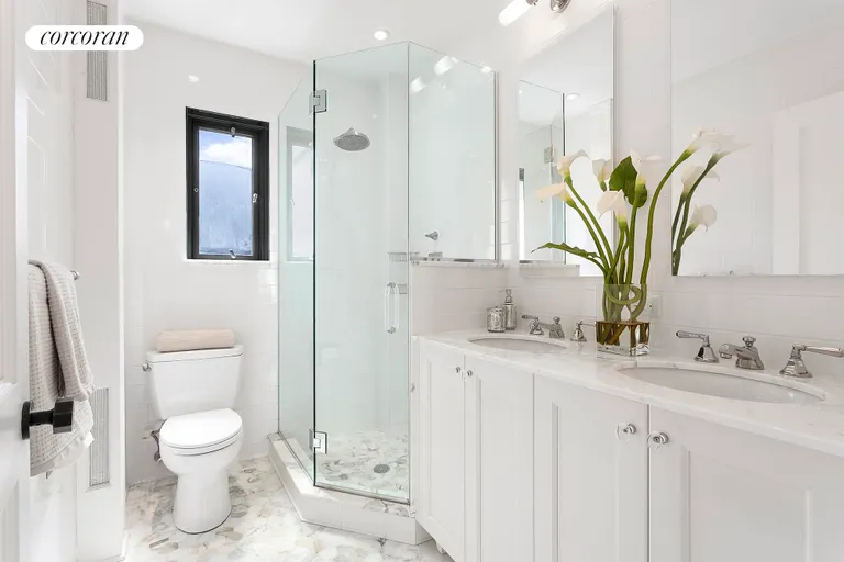 New York City Real Estate | View 122 East 82Nd Street, 9A | Mint Marble Bath with Dual Sinks & Heated Floors | View 9