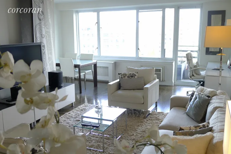 New York City Real Estate | View 392 Central Park West, 19J | Living and dining area with wall to wall windows | View 2