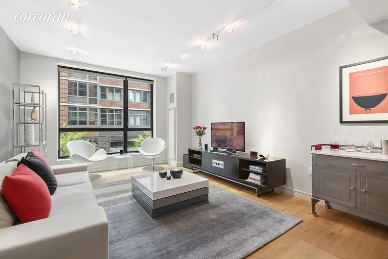 New York City Real Estate | View 540 West 28th Street, 2E | Spacious Living Area with Floor to Ceiling Windows | View 2