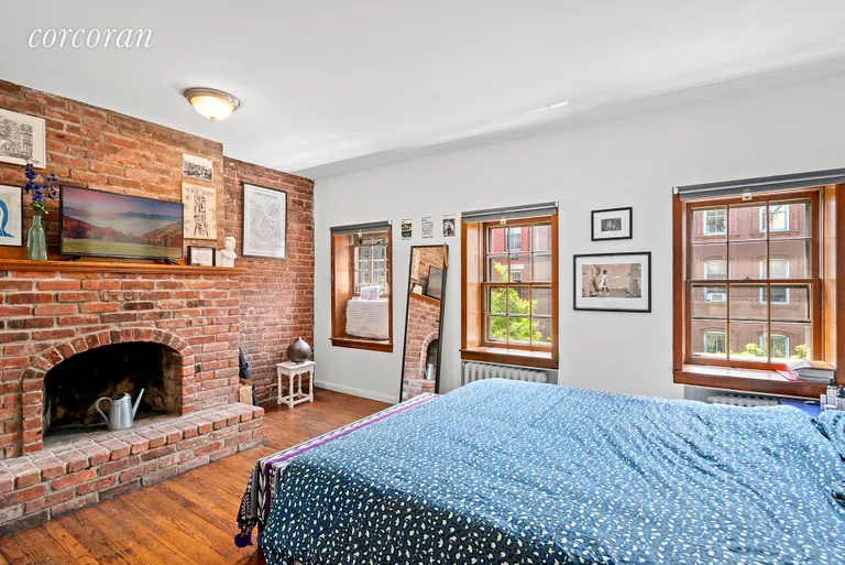 New York City Real Estate | View 251 West 21st Street, 3-4 | Master bedroom with with wood burning fireplace | View 5