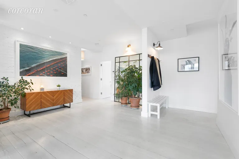 New York City Real Estate | View 138 Broadway, 5G | Grand gallery and entry foyer w exposed brick wall | View 7