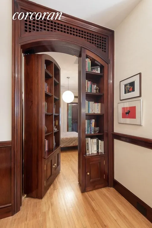 New York City Real Estate | View 35 East 68th Street, 3/4 | Wood Paneled Doors Lead to Hidden Bedroom | View 11