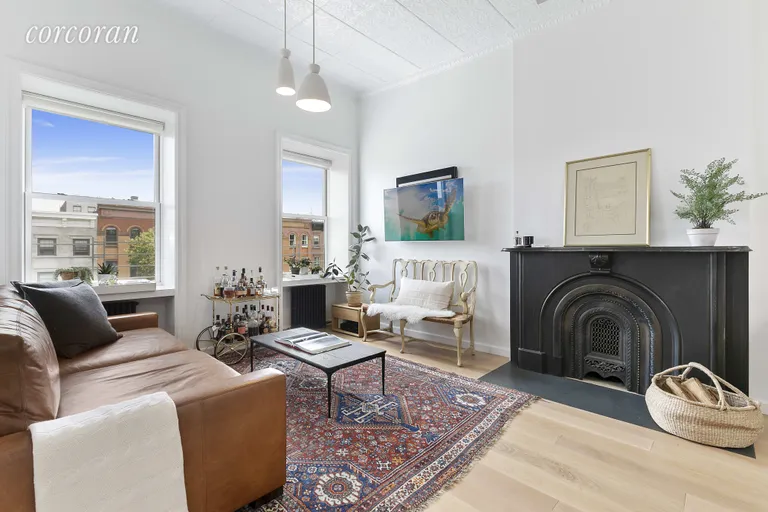 New York City Real Estate | View 86 2nd Place, 4 | Living room with wood burning fireplace  | View 3