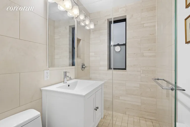 New York City Real Estate | View 30 East 9th Street, 1E | Windowed Bathroom with Glass-Enclosed Shower | View 6