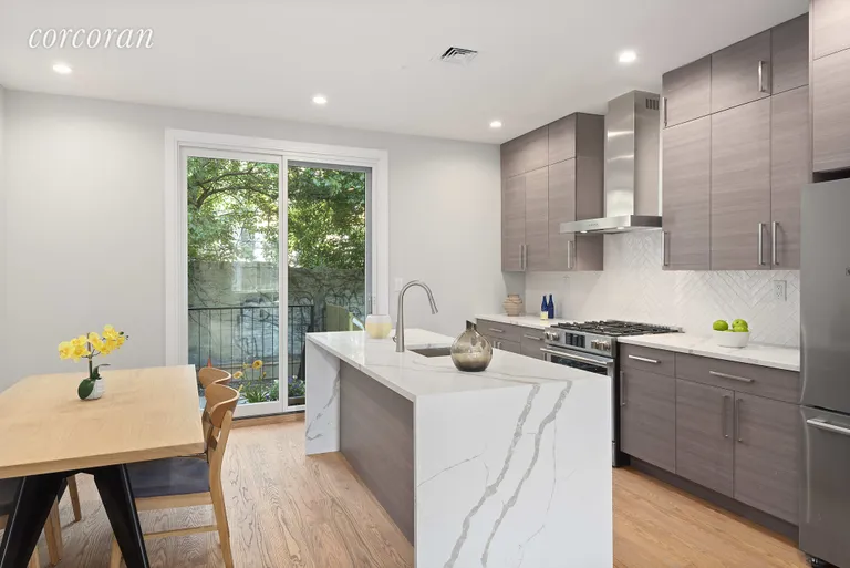 New York City Real Estate | View 27 Gunther Place | Waterfall countertops and space for dining! | View 3