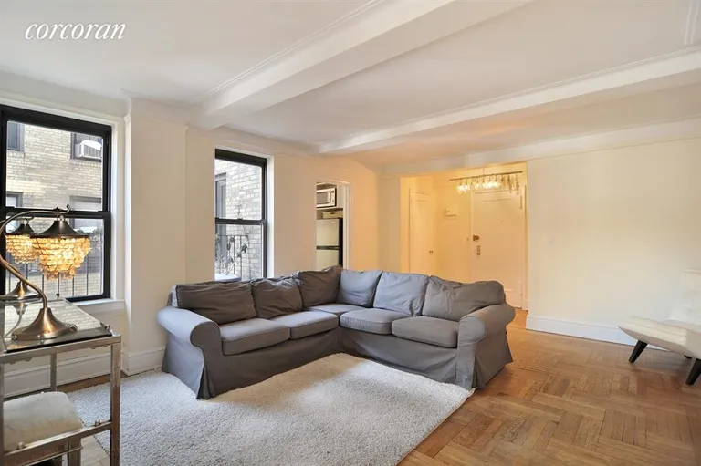 New York City Real Estate | View 333 East 53rd Street, 11A | Living Room - hardwood floors and  beamed ceiling | View 2