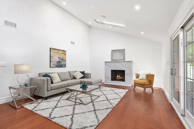 New York City Real Estate | View 1019 Ionia Avenue | Sunken Living Room w/ Wood Burning Fireplace | View 3