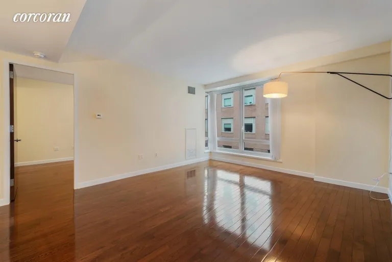 New York City Real Estate | View 462 West 58th Street, 7E | North-facing living room with oversized windows | View 2