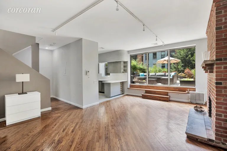 New York City Real Estate | View 212 West 15th Street, 3-4 | Living room with wood burning fireplace | View 2