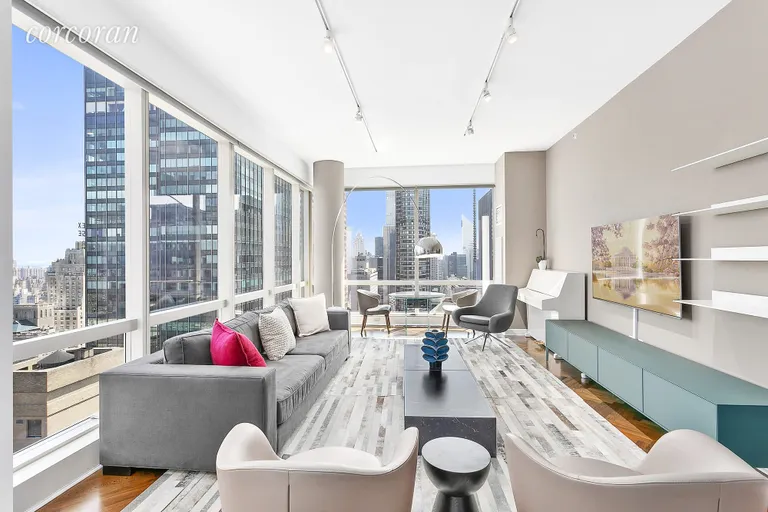New York City Real Estate | View 230 West 56th Street, 52A | Bright Corner Living Room w/ Park & City Views | View 2
