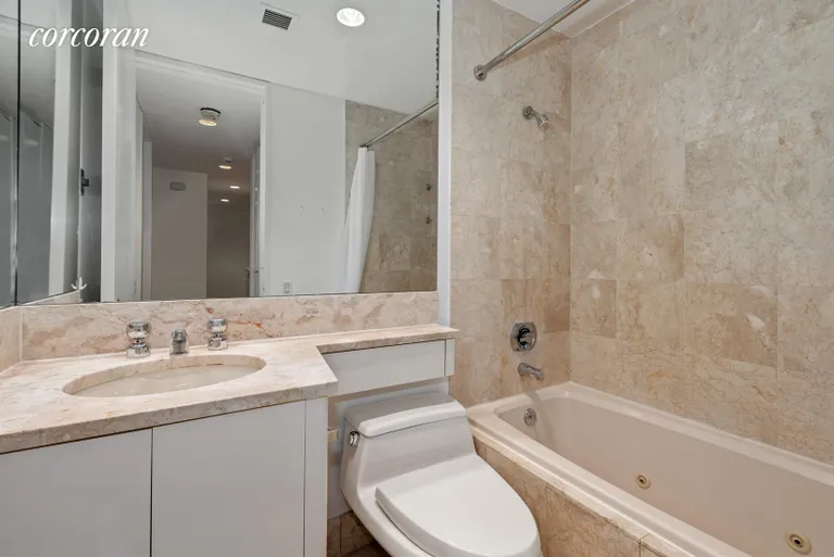 New York City Real Estate | View 100 United Nations Plaza, 5D | Marble bathroom with Jacuzzi bathtub | View 5