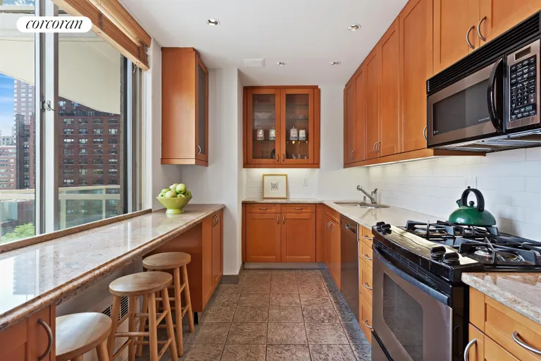 New York City Real Estate | View 300 East 74th Street, 10G | Windowed Kitchen with Dining Bar | View 3