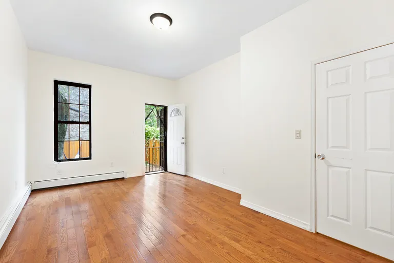 New York City Real Estate | View 1342 Gates Avenue, 1 | Master Bedroom: Garden Access and En Suite Bath! | View 5