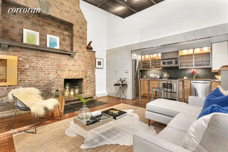 New York City Real Estate | View 131 West 11th Street, 2 | Living Room + Wood-Burning Fireplace | View 2