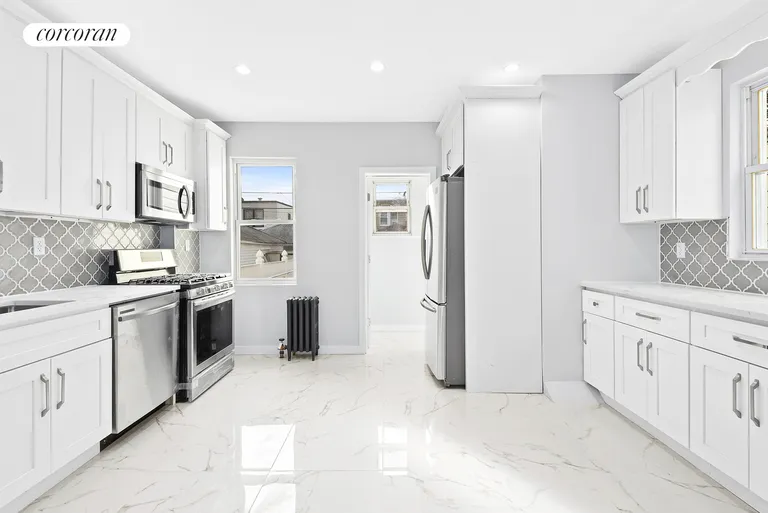 New York City Real Estate | View 69-24 66th Place | Gigantic windowed kitchen! | View 4
