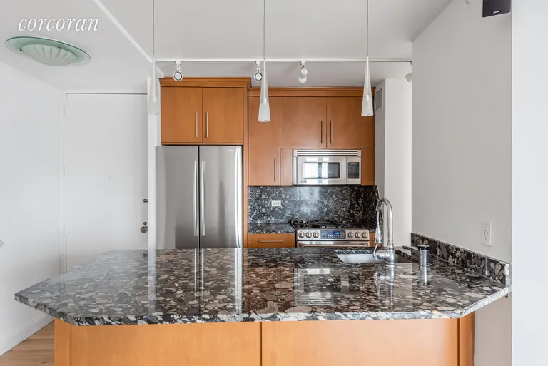 New York City Real Estate | View 415 East 37th Street, 39D | Renovated Kitchen with Breakfast Bar | View 2