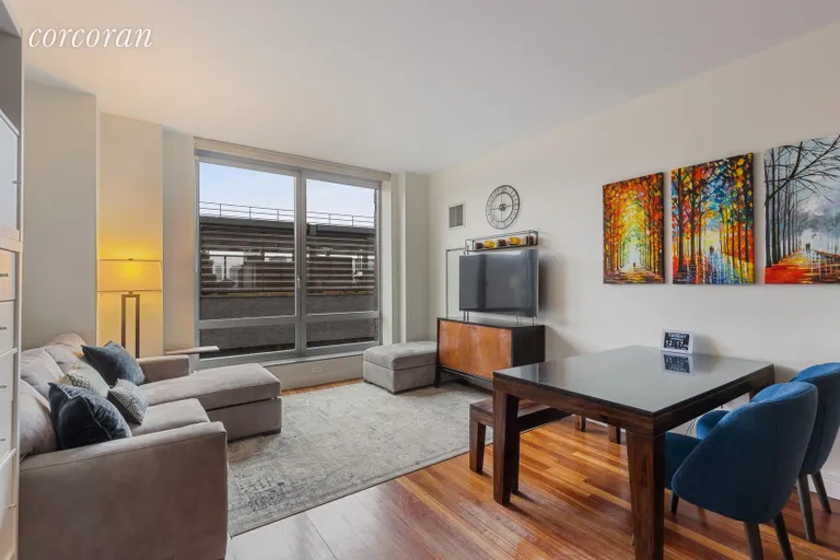 New York City Real Estate | View 30 West Street, 12G | Living Room with Oversized Windows | View 2