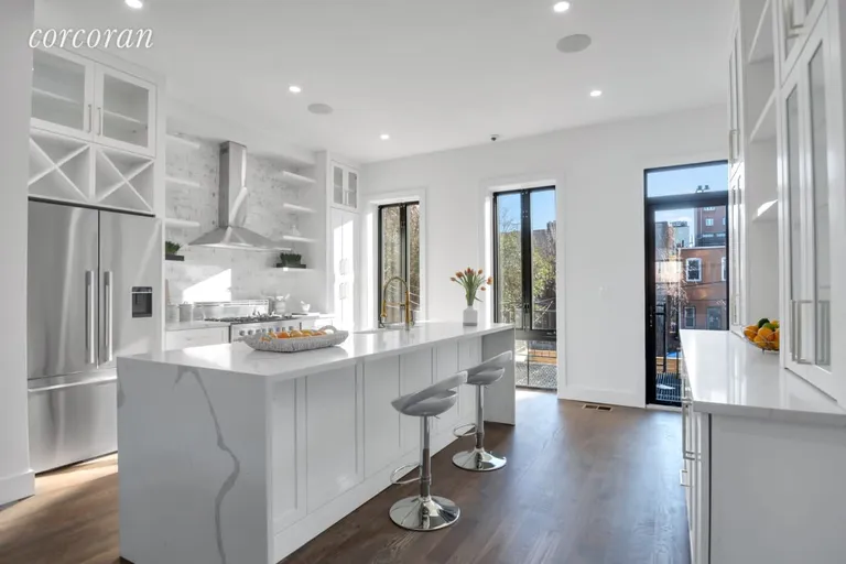 New York City Real Estate | View 1194 Saint Johns Place | Garden Facing Kitchen ft. 9' Waterfall Island | View 7