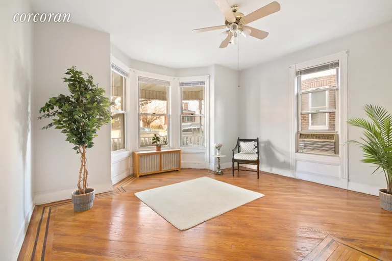 New York City Real Estate | View 262 77th Street | Apt living room with bay windows & original floors | View 3