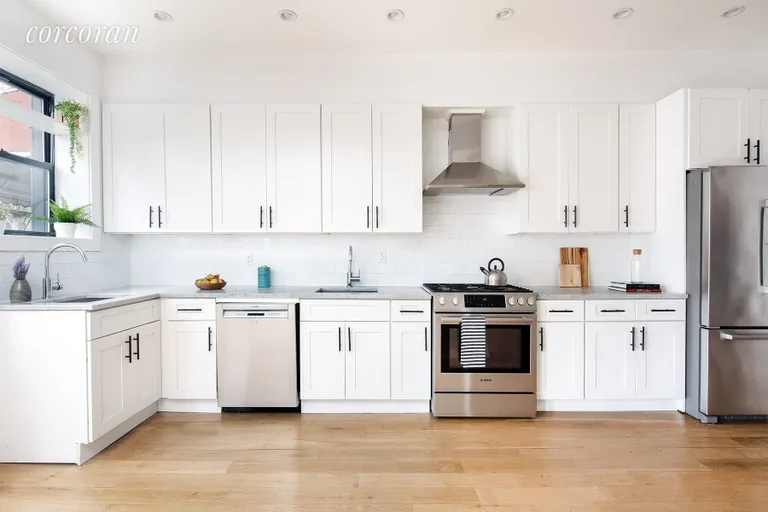 New York City Real Estate | View 1632 Union Street | Modern kitchen cabinetry with marble countertop | View 6