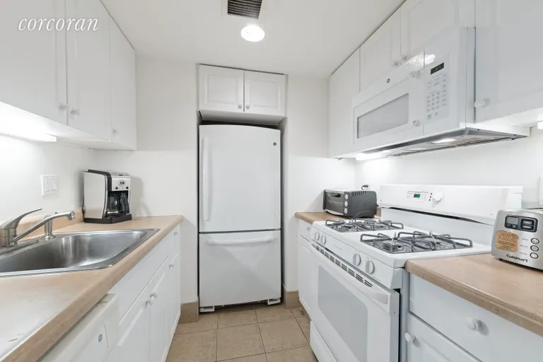 New York City Real Estate | View 40 East 61st Street, 11A | Galley kitchen with full size appliances | View 2