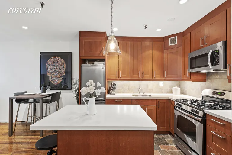 New York City Real Estate | View 67 East 11th Street, 204 | Kitchen with white stone countertops | View 2