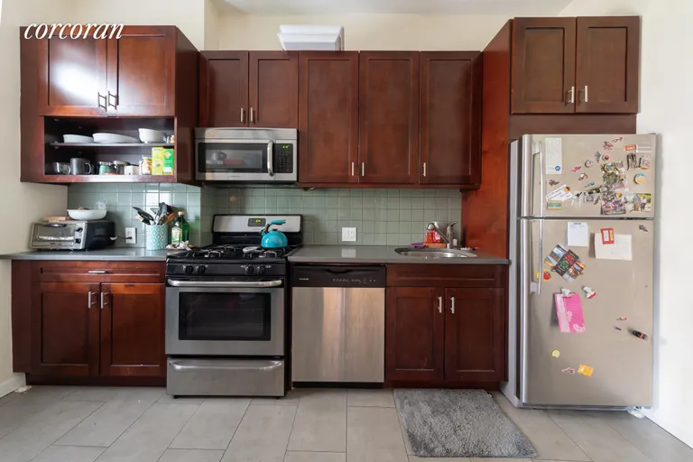New York City Real Estate | View 989 Seneca Avenue, 1 | Separate Kitchen with stainless steel appliances | View 3