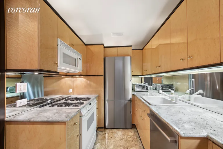 New York City Real Estate | View 721 Fifth Avenue, 60AB | Marble Counters and Floors with New SS Appliances | View 9