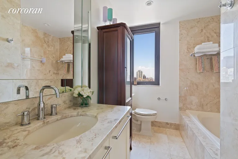 New York City Real Estate | View 100 United Nations Plaza, 37E | En suite windowed marble bathroom | View 6