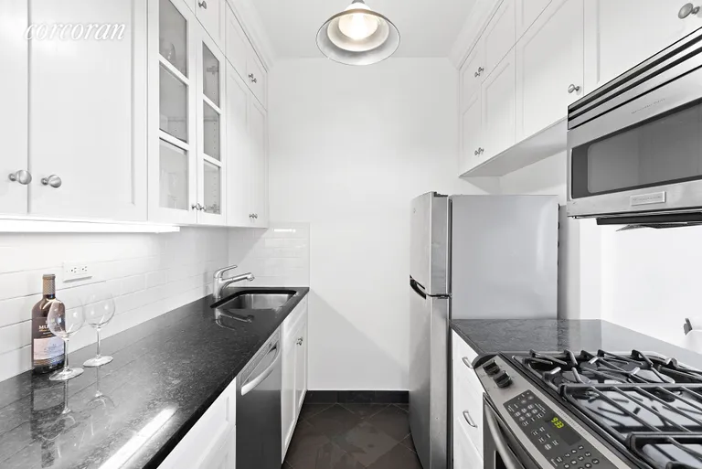 New York City Real Estate | View 77 Bleecker Street, 1114W | Modern white kitchen with granite countertops. | View 4