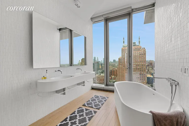 New York City Real Estate | View 56 Leonard Street, 25A EAST | Travertine and marble clad master bathroom | View 9