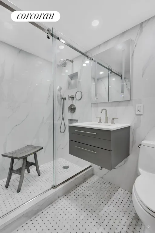 New York City Real Estate | View 235 East 87th Street, 10C | New primary bathroom w/floating sink & big shower | View 8