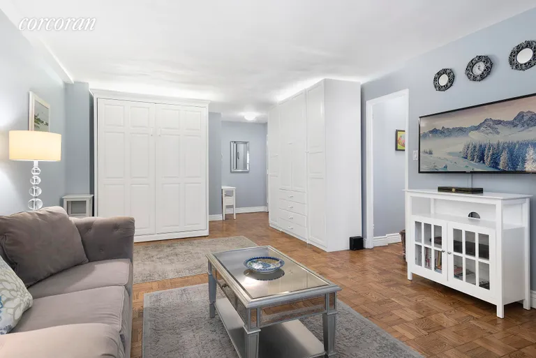 New York City Real Estate | View 233 East 69th Street, 5O |  Living room w/matching Murphy bed/wardrobe | View 2